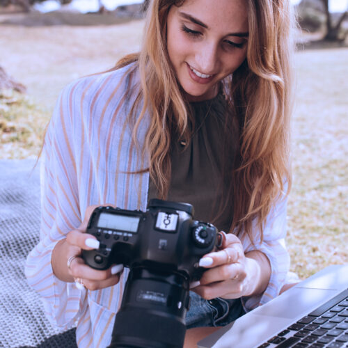 Girl checking the settings on her camera