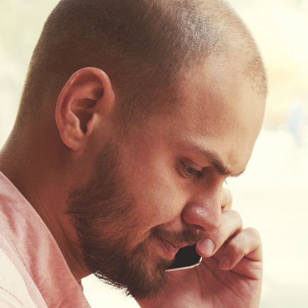 Man Using Laptop and Phone