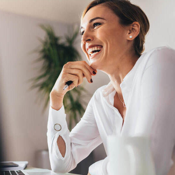 A woman watches a webinar on her laptop.