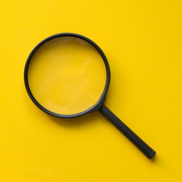 close up magnifier glass on yellow background